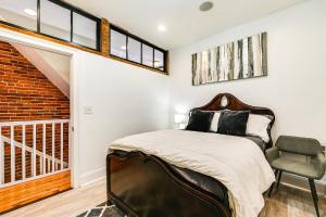 a bedroom with a bed and a staircase at Bright Harrisburg Retreat about 14 Mi to Hersheypark! in Harrisburg