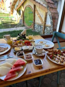 a wooden table with plates of food on it at Cozy House in Dilijan