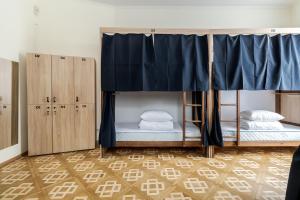 a room with two bunk beds and cabinets at Soborniy Hostel in Lviv