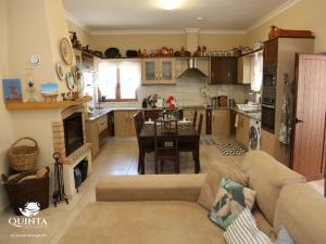 a kitchen and living room with a couch and a table at Quinta dos Sapos in Silves