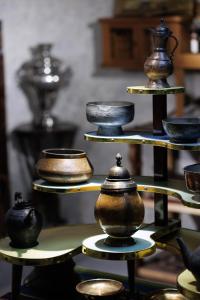 a display of pots and bowls on a shelf at Отель-музей in Tashkent