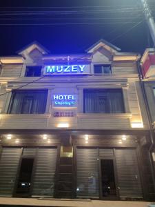 a hotel with a sign on the front of it at Отель-музей in Tashkent