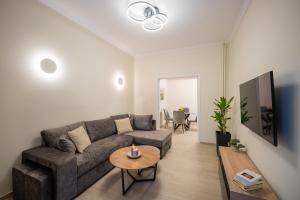 a living room with a couch and a table at Central 2 Bdrm Aprt In Koukaki! in Athens