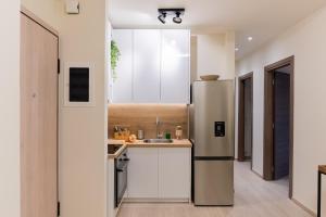 a kitchen with a refrigerator and a sink at Central 2 Bdrm Aprt In Koukaki! in Athens