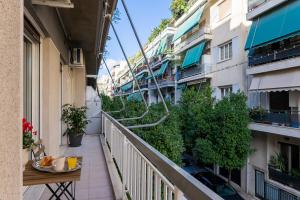 an apartment balcony with a table and plants at Central 2 Bdrm Aprt In Koukaki! in Athens