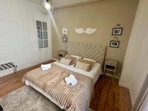 a bedroom with a large bed with two towels on it at La Douceur - 4 personnes - BCLA in Le Mans