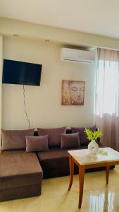 a living room with a brown couch and a table at Downtown Studio 41 in Serres