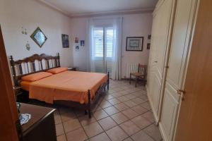 1 dormitorio con 1 cama con sábanas de color naranja en Ai piedi dell'Etna, en Belpasso
