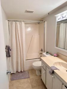 a bathroom with a shower and a toilet and a sink at Stunning 2-Bd Condo Naples, 55+, pool, Chickee, golf in Naples