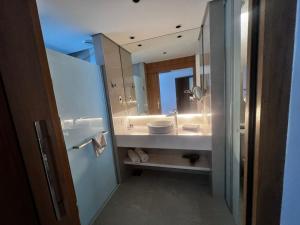 a bathroom with a sink and a mirror at Hotel Nacional Apart Lux 1 in Rio de Janeiro