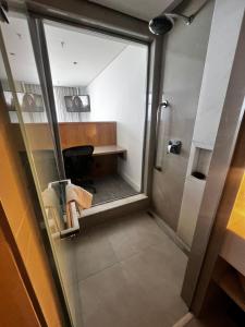 an office with a glass door leading to a desk at Hotel Nacional Apart Lux 1 in Rio de Janeiro