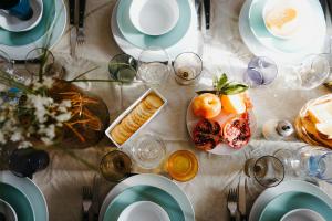 a table with plates and bowls of food on it at Moulin Morin Domaine historique aux portes de Bayeux in Vaucelles