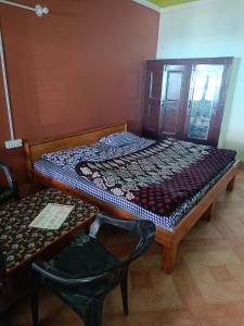 Ashirwad Guest House tesisinde bir odada yatak veya yataklar