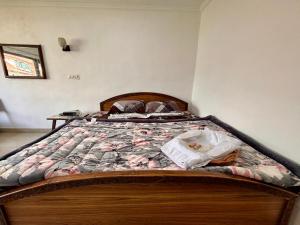 a bedroom with a bed with a quilt on it at Hotel Crescent in Srinagar