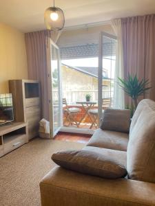 a living room with a couch and a television at El apartamento de Adriana en Torrelavega. in Torrelavega