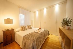 a bedroom with a bed and a dresser and a window at Lake view 14 in Pisogne
