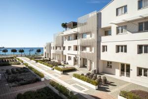an apartment building with a view of the ocean at Humagum Sea View Apartment - Garden Palace Umag in Umag