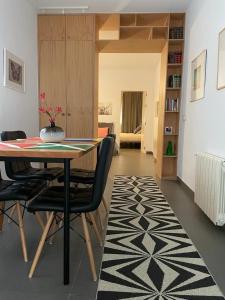 a dining room with a table and some chairs at Chipibeach, Hostal Boutique in Chipiona