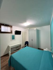 a hospital room with a bed and a television at Stanze Borgo Antico in Montenero di Bisaccia