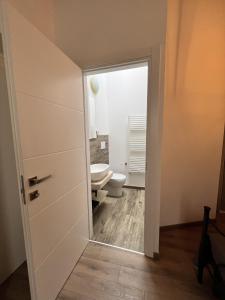 an open door to a bathroom with a toilet at Stanze Borgo Antico in Montenero di Bisaccia