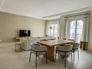 a dining room with a wooden table and chairs at Appartement Centre Cannes in Cannes