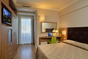 Кровать или кровати в номере Hotel Rossini