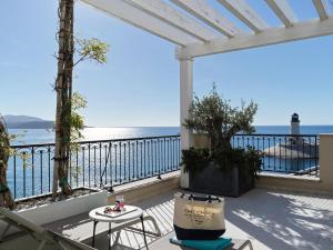 a balcony with a view of the ocean at The Chedi Luštica Bay in Tivat