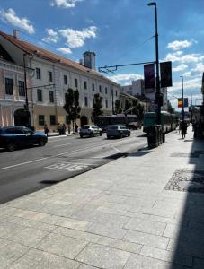 a city street with cars driving down the road at NDL Downtown in Cluj-Napoca