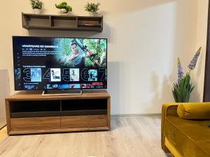 a living room with a flat screen tv on a stand at NDL Downtown in Cluj-Napoca
