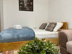 a living room with a bed and a couch at NDL Downtown in Cluj-Napoca
