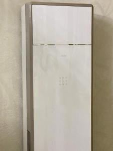 a white refrigerator in the corner of a room at 4х комнатная квартира in Bishkek