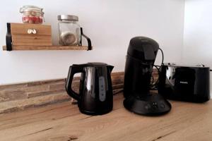 two black appliances are sitting on a wooden floor at La Madoca in Flayosc