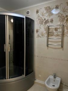 a bathroom with a shower and a toilet and a sink at 4х комнатная квартира in Bishkek