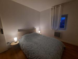 um quarto com uma cama e duas luzes em duas mesas em T2 Chic Green & Yellow em Mazamet