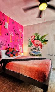 a bedroom with flamingos painted on the wall at MESON AMELIA in San Miguel de Allende