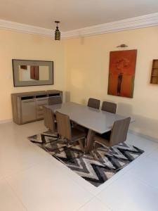 a dining room with a table and chairs at Good Time Guaranteed •7 in Dakar