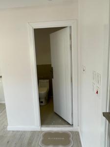 an open door to a bathroom with a toilet at صحراء الحره in AlUla