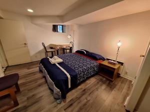 a bedroom with a bed and a table and a tableablish at Midtown Toronto Next to Subway Line 1 in Toronto