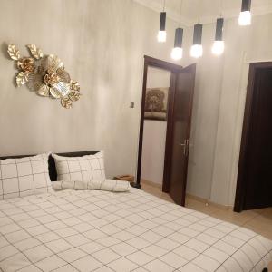 a bedroom with a large bed and a chandelier at Vaggoula's Luxury Apartment 1 in Serres