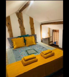 a bedroom with a large bed with yellow pillows at House on the Beach in Apúlia