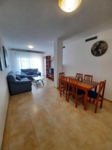 ein Wohnzimmer mit einem Tisch und einem Sofa in der Unterkunft Amplio apartamento céntrico in Peñíscola