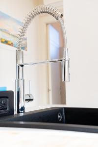 a kitchen sink with a chrome kitchen faucet at Blu Iris - Deluxe apartment with jacuzzi in Lesa