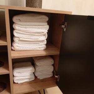 a stack of towels in a closet at Vaggoula's Luxury Apartment 1 in Serres