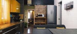 a kitchen with a stainless steel refrigerator and a microwave at LA BOHEME in Telde