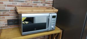 a microwave with a wooden box on top of it at LA BOHEME in Telde