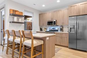 a kitchen with stainless steel appliances and wooden cabinets at Fairway Getaway #55 townhouse in Santa Clara