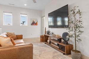 a living room with a couch and a tv at Fairway Getaway #55 townhouse in Santa Clara
