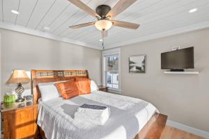 a bedroom with a bed with a ceiling fan at Lady of The Lake in Laconia