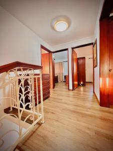 a hallway with a staircase in a room with wooden floors at N.Caunhye Villa in Pereybere