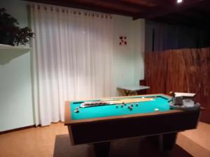 a pool table in a living room with a pool table at LE PETIT VERMONDOIS in Le Bacon